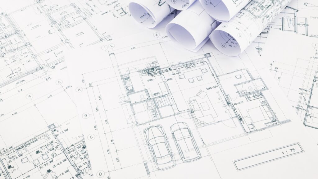 Architectural plans and tools symbolizing fast-tracked permitting and rebuilding support in Los Angeles