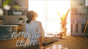 woman relaxing indoors in natural sunlight near window in Los Angeles home by REAL Arch